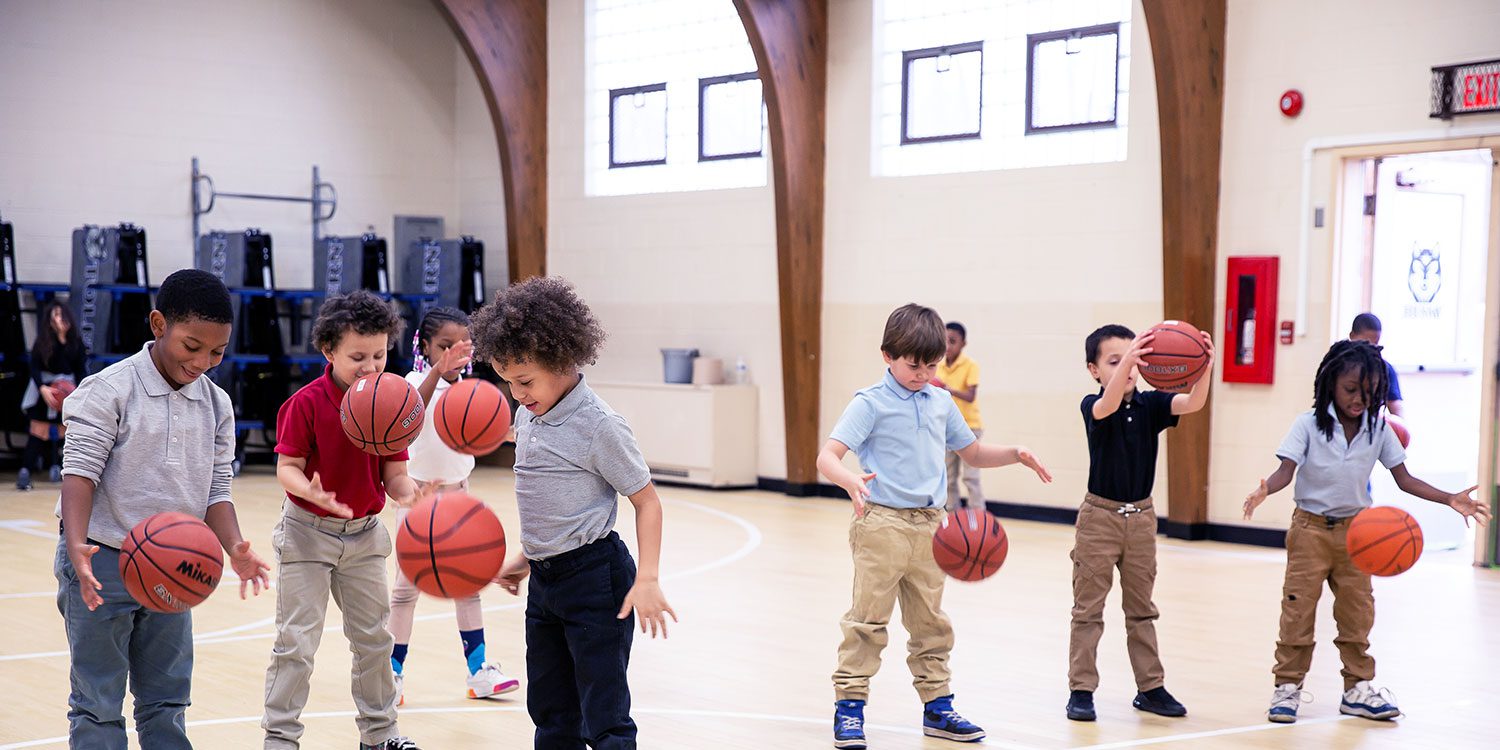 A group of elementary students playing basketball