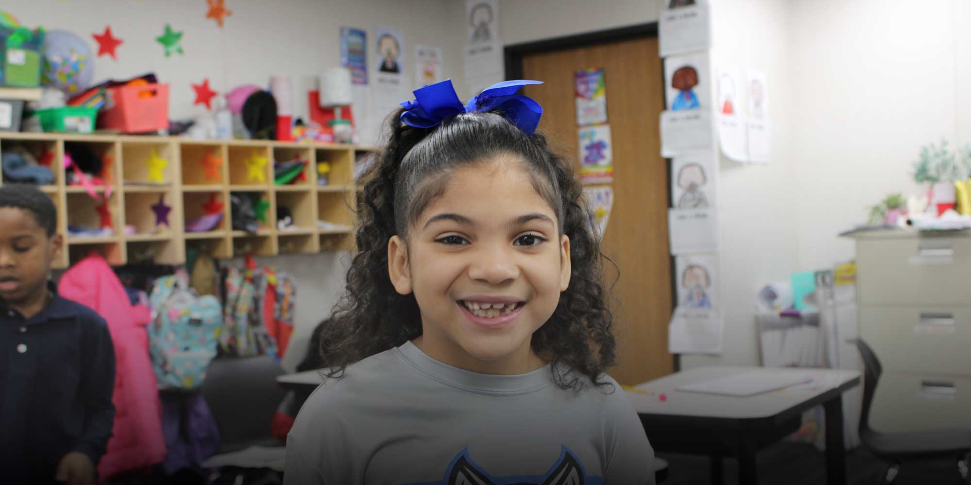 Smiling student sitting in classroom